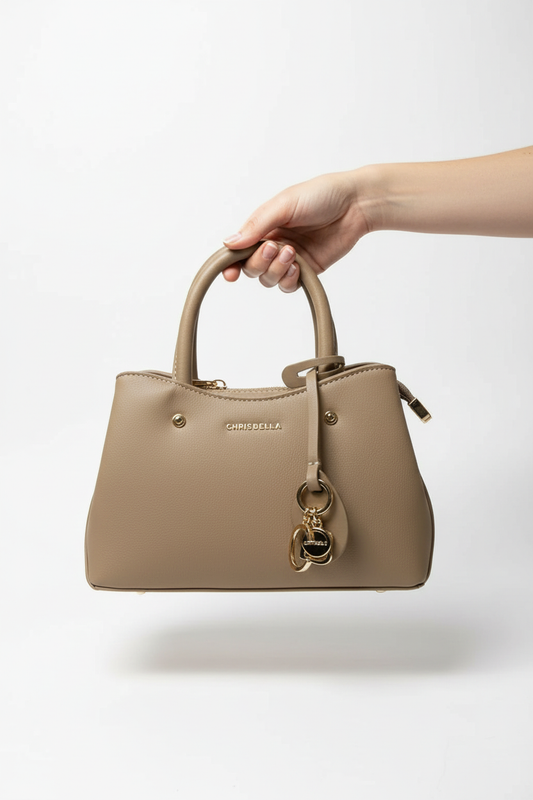 Beige Chrisbella handbag carried by hand