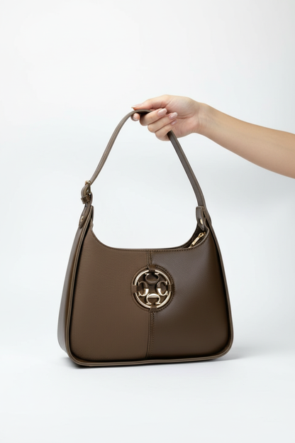 Olive brown Chrisbella shoulder bag carried by hand